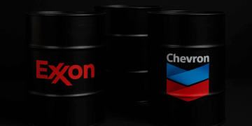 Barriles de petróleo Exxon y Chevron sobre fondo oscuro Exxon