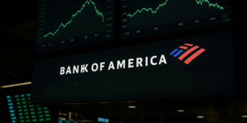 Pantalla financiera muestra logo de Bank of America y mensaje “Trade Deal Euphoria to Cool” con gráficos bursátiles cayendo